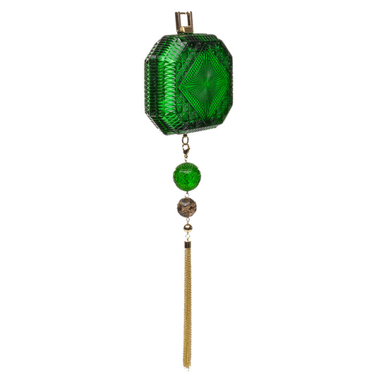 A green faceted cut glass inspired clutch bag with a geometric pattern, hanging from a gold-tone metal loop with a tassel and decorative beads below, shown against a plain white background.
