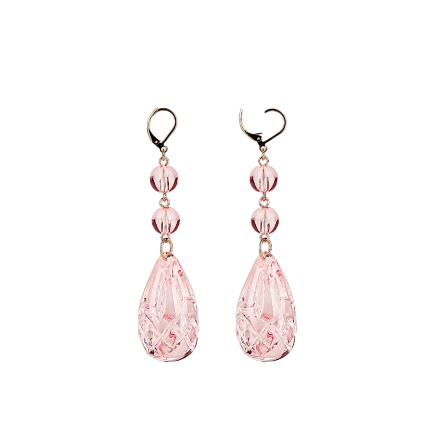 A pair of dangling earrings with faceted light pink teardrop beads and three smaller round pink beads, suspended from gold-tone hooks on a plain white background.