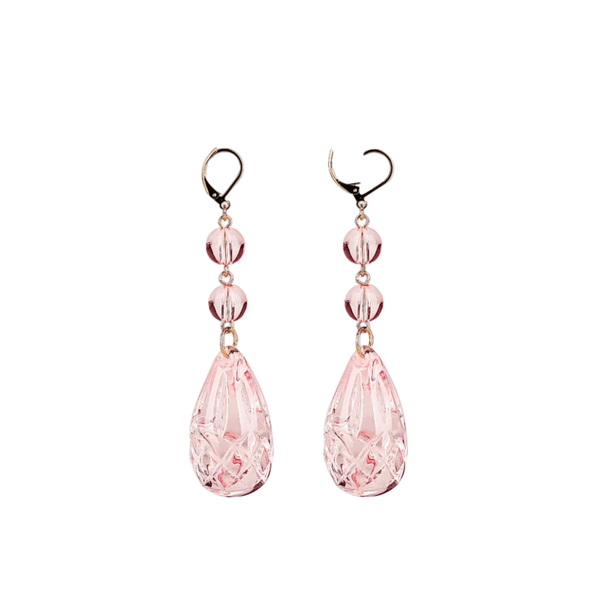 A pair of dangling earrings with faceted light pink teardrop beads and three smaller round pink beads, suspended from gold-tone hooks on a plain white background.