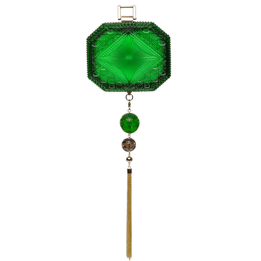 A green cut-glass inspired clutch bag featuring a faceted octagonal top, a hanging tassel, and decorative beads, shown against a plain white background.
