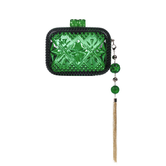 A green textured clutch bag with a black braided border, featuring an embossed geometric star pattern, a matching green top loop, and a dangling charm with green beads and a gold tassel, shown on a plain white background.